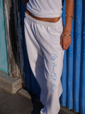 The Signature Jogger in White, script printed down the leg