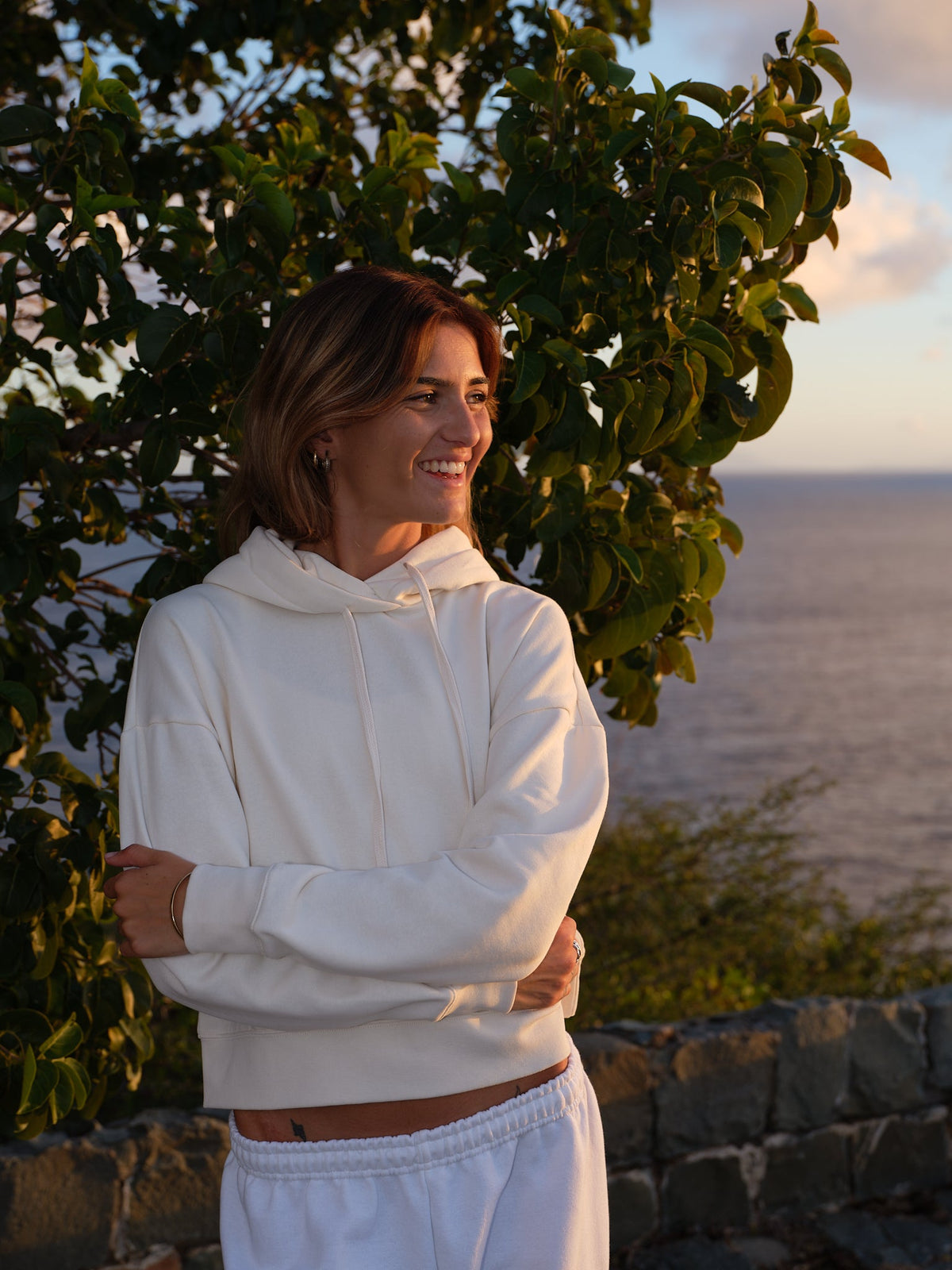 The Heart Hoodie in Ivory, front, on the island